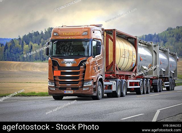 Scania S730 truck of AH-Trans Oy hauls four chemical tank containers on road, ADR codes denoting Sodium. Long transport. Salo, Finland. May 15, 2021