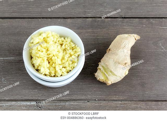 A piece of ginger and chopped ginger