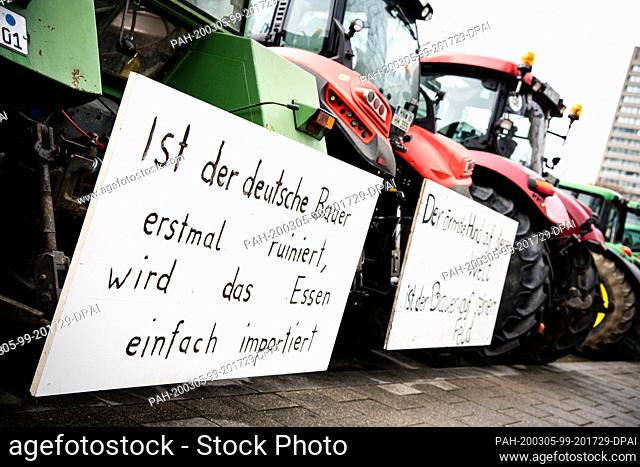 05 March 2020, Bavaria, Munich: Signs with the inscriptions ""Once the German farmer is ruined, the food is simply imported"" and ""The poorest dog in the world...