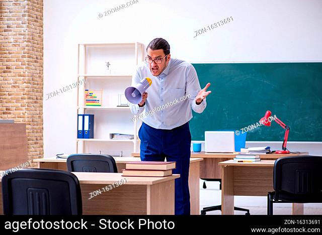 Young teacher in front of green board