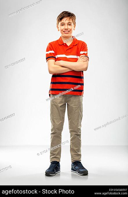 portrait of happy smiling boy in red polo t-shirt