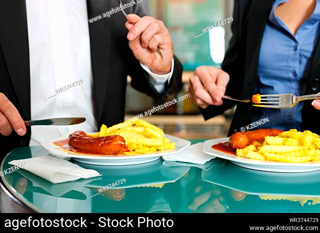 Couple with snack for lunch - sausage and fries