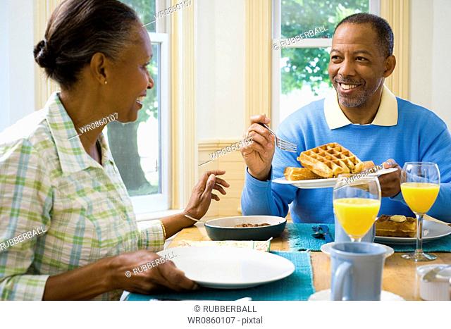 Senior man and a senior woman having breakfast