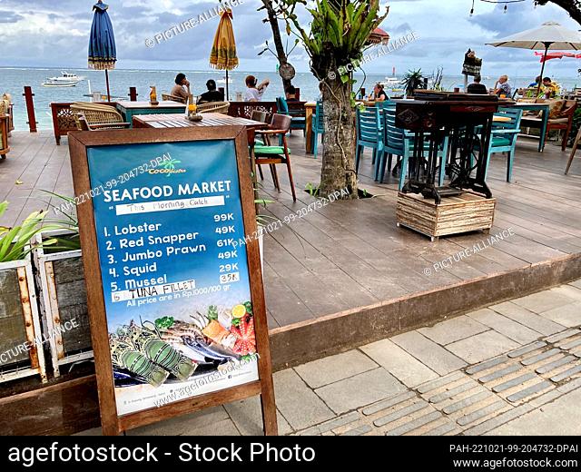 19 October 2022, Indonesia, Sanur: Only a few tables are occupied in a restaurant on the beach of the resort town. On the Indonesian vacation island of Bali