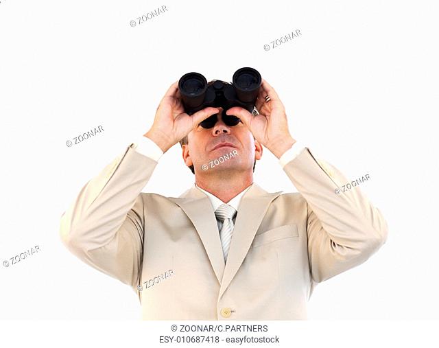 Confident businessman looking through binoculars