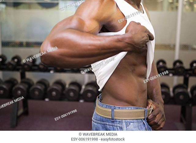 Mid section of a muscular man in gym