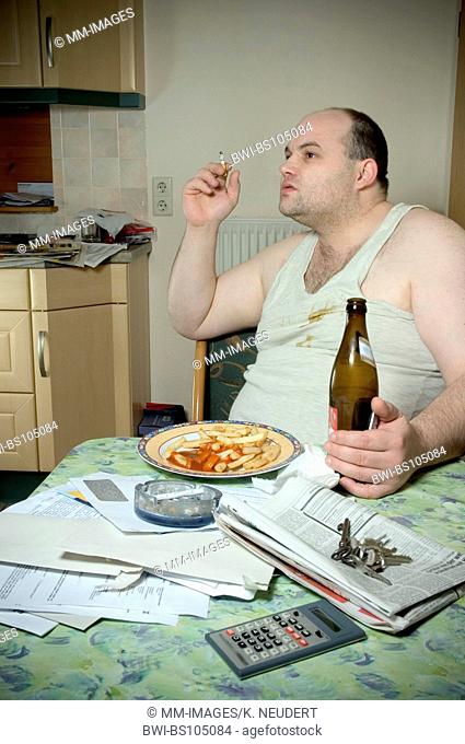 man in undershirt sitting in the kitchen with cigarette, french fries and beer, Ruhr Area