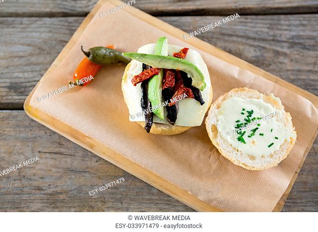 Overhead view of vegetables with cheese and bun