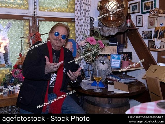 19 January 2022, Berlin: Singer Frank Zander sits in his private pub in Charlottenburg amid old photos, souvenirs, odds and ends and newspaper articles