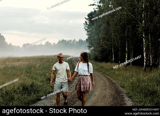 Couple walking on dirt road