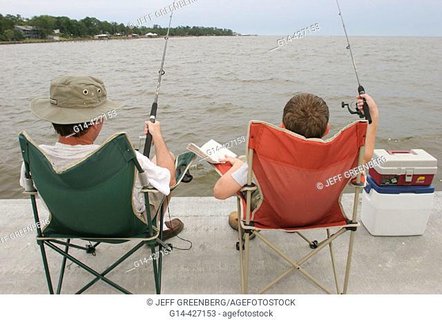 Father and son fishing. Mobile Bay, Municipal Park Pier, Fairhope. Alabama. USA