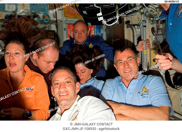 The STS-118 and Expedition 15 crews gather for a farewell ceremony in the Zvezda Service Module of the International Space Station