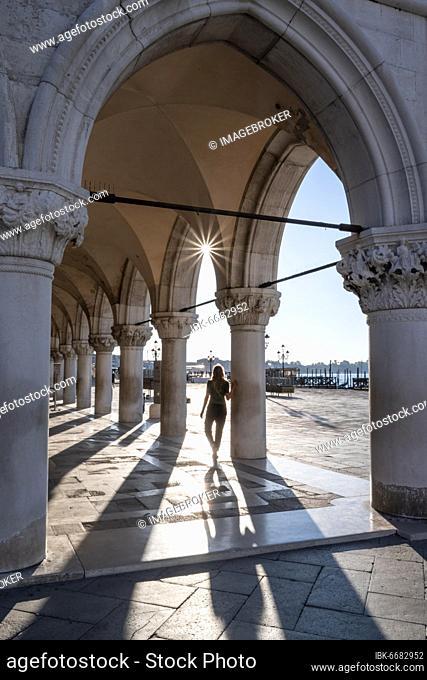 Sun shining through columns, Doge's Palace at St. Mark's Square, Venice, Veneto, Italy, Europe