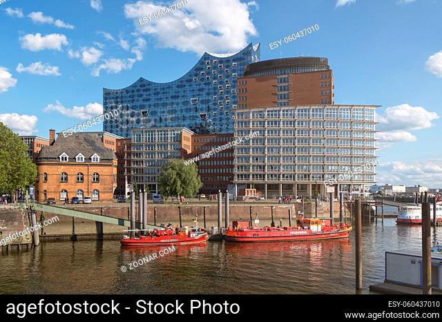 HAMBURG, GERMANY - 29 MAY 2019: Hamburg Harbor Fire Fighter Boats and Elbphilharmonie Concert Hall in the background by day