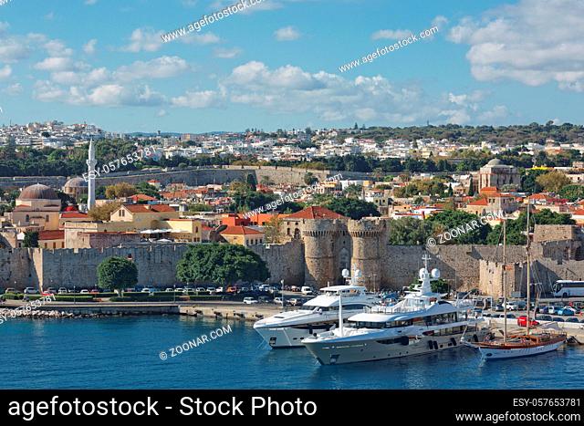 RHODES, GREECE - OCTOBER 26, 2017: Marine Gate and the fortifications of the Old Town of Rhodes, view from Mandraki harbour, Rhodes, Greece
