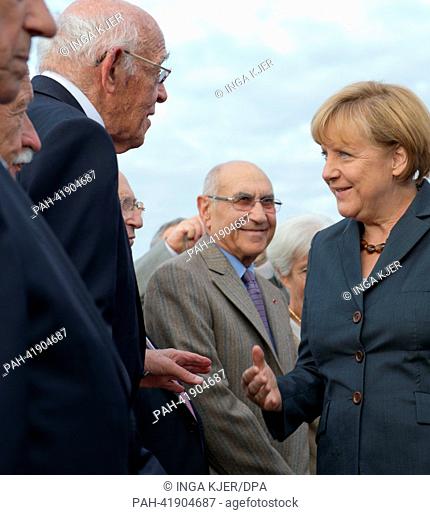 German chancellor Angela Merkel (CDU, C) talks with Holocaust survivors during her visit of the former concentration camp Dachau, Germany, 20 August 2013