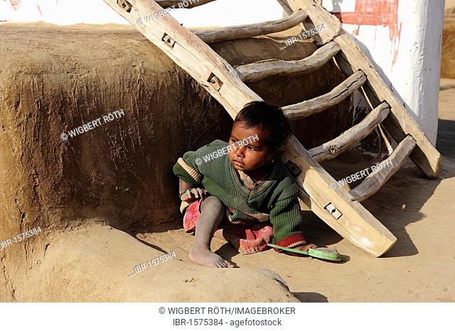 Little boy playing at an entrance ladder, Thar Desert, Rajasthan, North India, India, Asia