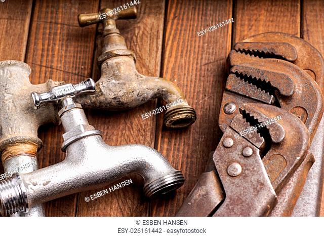 plumbing tools lying with old pipes and faucets