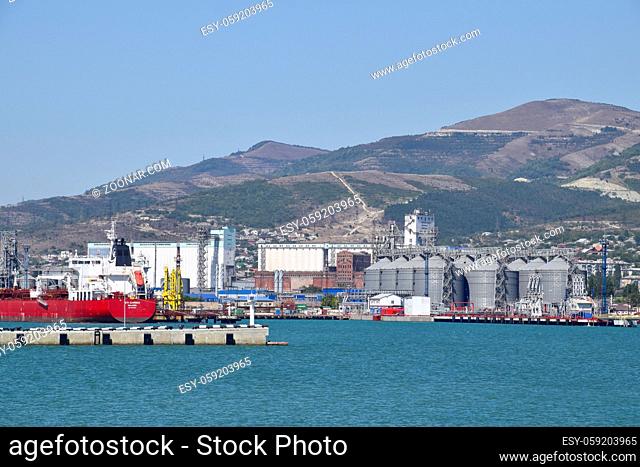 Novorossiysk, Russia - September 9, 2016: international seaports. Cargo port with port cranes. Sea bay and mountainous coast