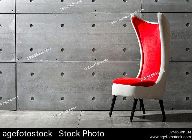 modern red chair and concrete wall. place for text