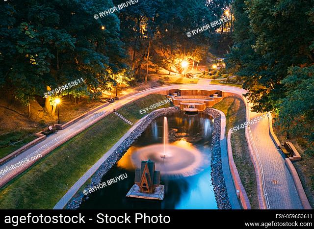 Gomel, Homiel, Belarus. Top Scenic View Of Park Watercourse Channel Flowing Into River In City Park In Evening Or Night Illumination