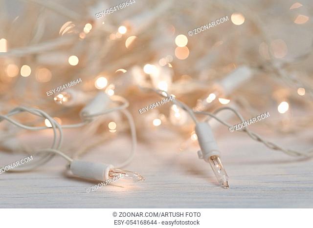 white christmas lights on retro vintage wooden background with shallow focus