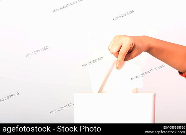 Young woman flu she using hand taking pulling white facial tissue out of from a white box for clean handkerchief, studio shot isolated on white background