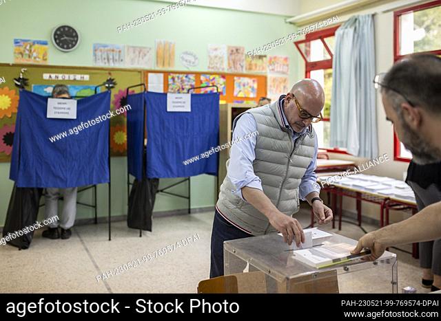 21 May 2023, Greece, Athen: Voters cast their ballots at a polling station. These are the first Greek parliamentary elections since the country's economy ceased...