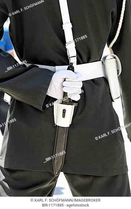 Back view of a guard, a white hand in glove covers the handle of a dagger in the belt, Dolmabahce Palace, Besiktas, Istanbul, Turkey