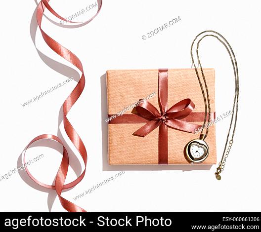 Craft gift box with vintage watches and curved ribbon isolated on white background