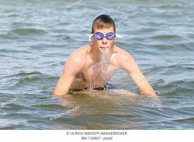 Boy swims in the sea
