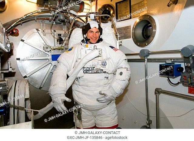 Astronaut Stanley G. Love, STS-122 mission specialist, participates in an Extravehicular Mobility Unit (EMU) spacesuit fit check in the Space Station Airlock...