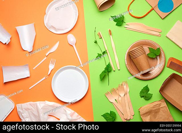 non-degradable plastic waste from disposable tableware and a set of dishes from environmental recycled materials on a green background