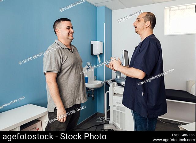 Doctor and patient talk in the consultation and smile