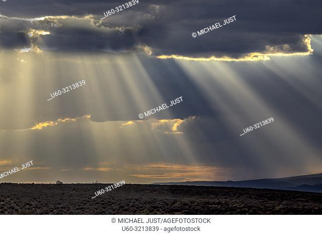 Stormy skies pass through the Southern Utah landscape and produce sunbeams at sunset