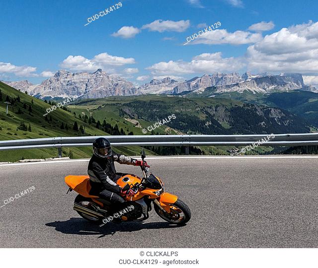 Motorbike on the road to Passo Pordoi, Arabba, Dolomites, Veneto, Italy
