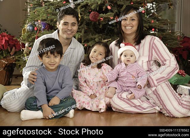 Hispanic family in pajamas on Christmas