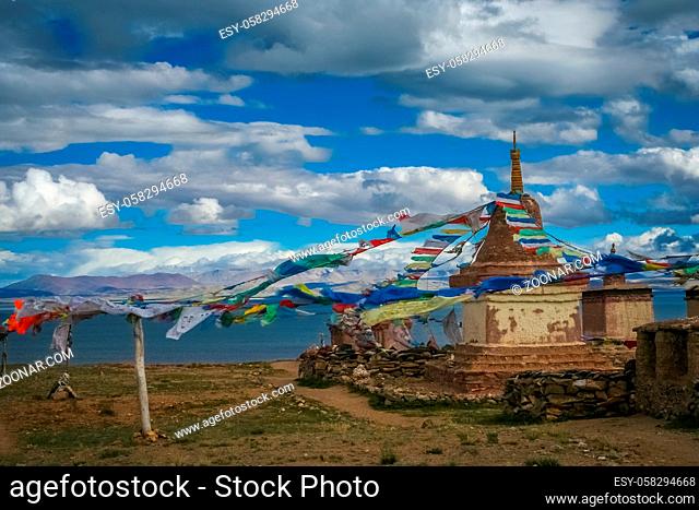 Small old Tibetan monastery and praying mills on a hill above holy Lake Manasarovar, Tibet