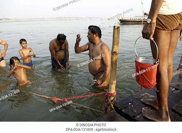Devotees bathing in river ; Triveni sangam ; Allahabad ; Uttar Pradesh ; India