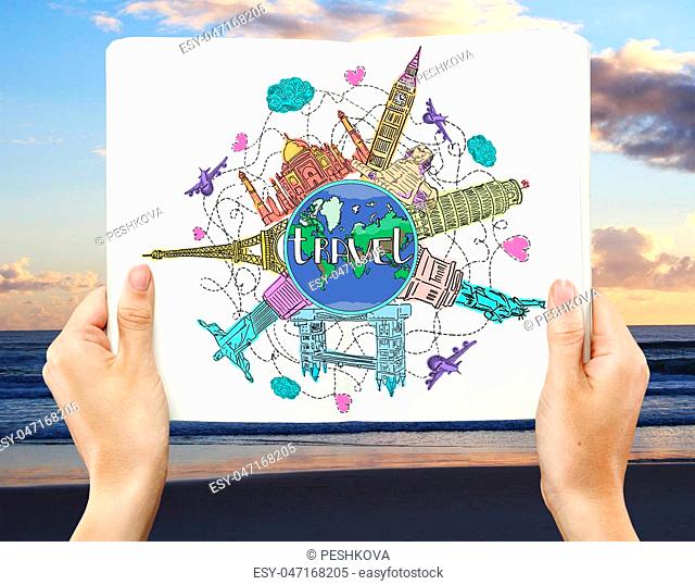 Close up of hands holding open book with creative colorful travel sketch on beach background. Traveling concept