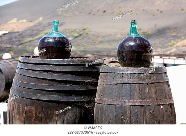 Barrels and big bottles with grape wine - malvasia. Lanzarote, Spain