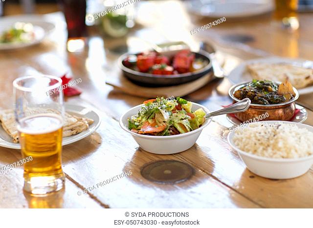 salad with other food on indian restaurant table