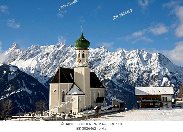 Parish and pilgrimage church of St. Bartholomew, Baroque church, in front of mountain range, Bartholomäberg, Montafon, Vorarlberg, Austria