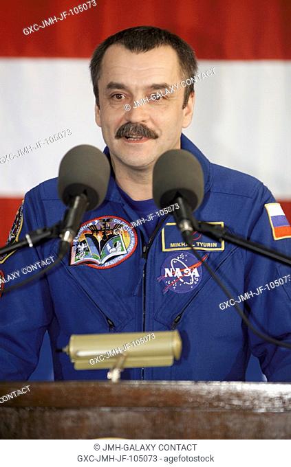 Cosmonaut Mikhail Tyurin, Expedition Three flight engineer representing Rosaviakosmos, speaks from the podium in Hangar 990 at Ellington Field during the...