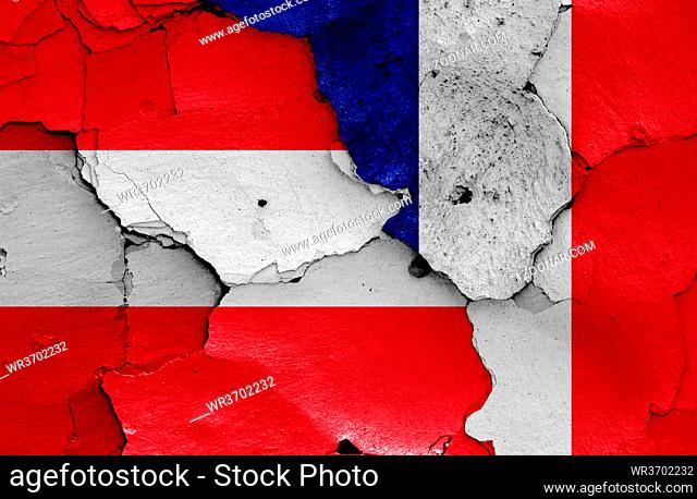 flags of Austria and France painted on cracked wall