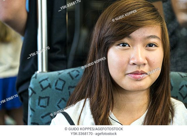Berlin, Germany. Attractive, teenage Asian girl traveling and commuting by U-Bahn through the German capitol