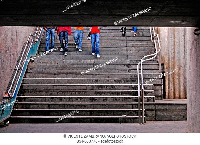 People descending stairway. RENFE undreground pass. Badalona, Catalonia, Spain