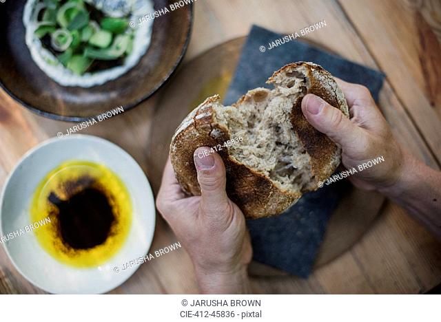 Personal perspective hands breaking bread