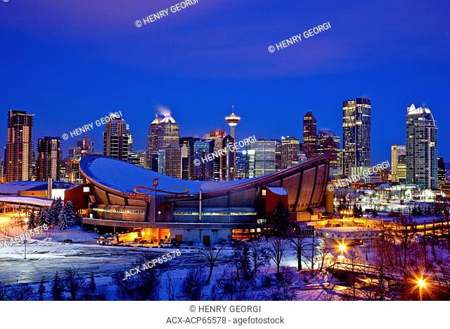 Calgary skyline at night in winter with Scotiabank Saddledome in foreground, Calgary Alberta, Canada