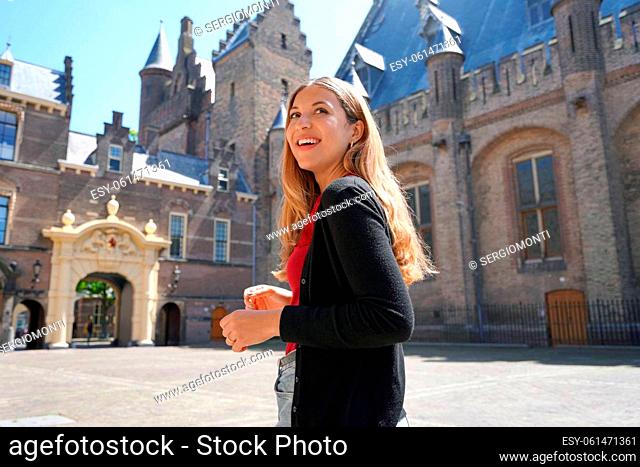 Young student girl visiting the complex of buildings of Binnenhof in The Hague, Netherlands